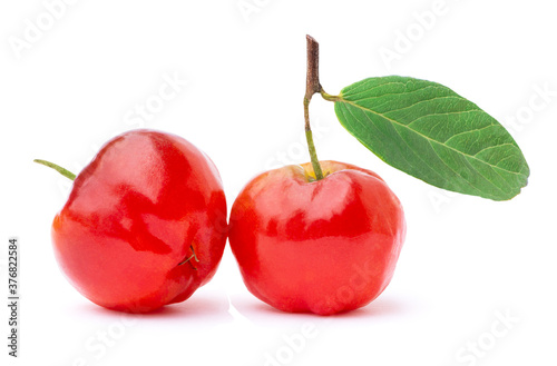 Two red acerola cherry fruit with green leaf isolated on white background. 