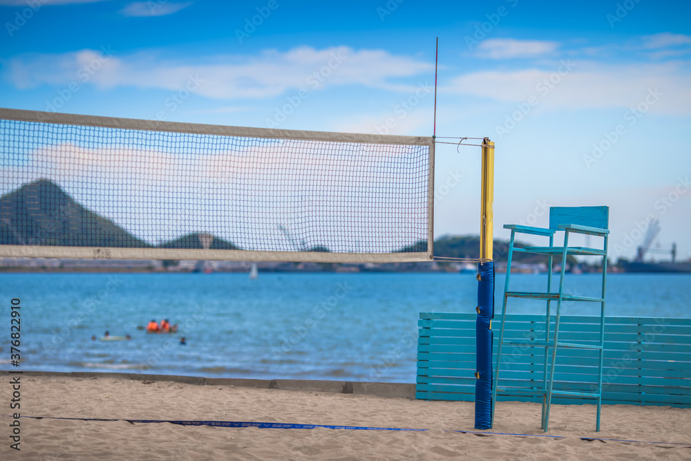 Blurred abstract background of seat made of wood and painted in blue, for sitting on beach volleyball.