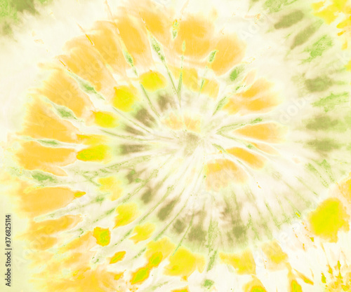 Spiral tie dye pattern wallpaper background in gold, yellow and matte green.