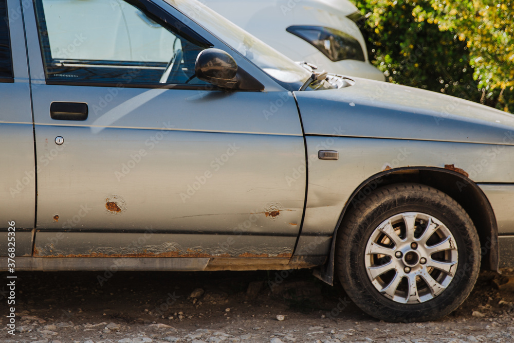 Car door and auto fender with heavy rust. Needs repair, road salt damage