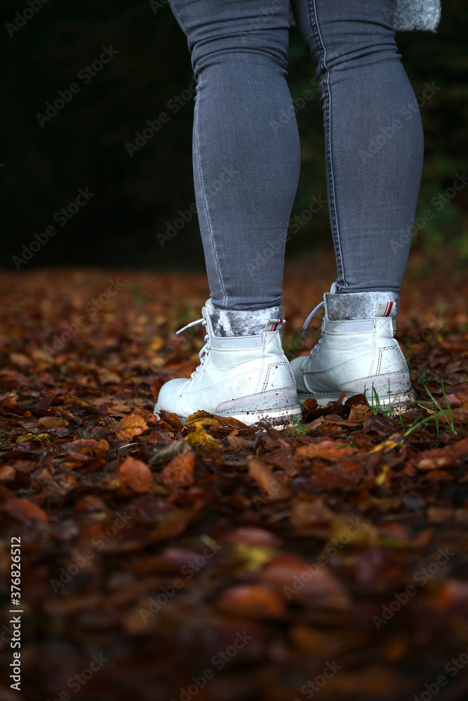 Standig on fallen leafs with boots autum vibes