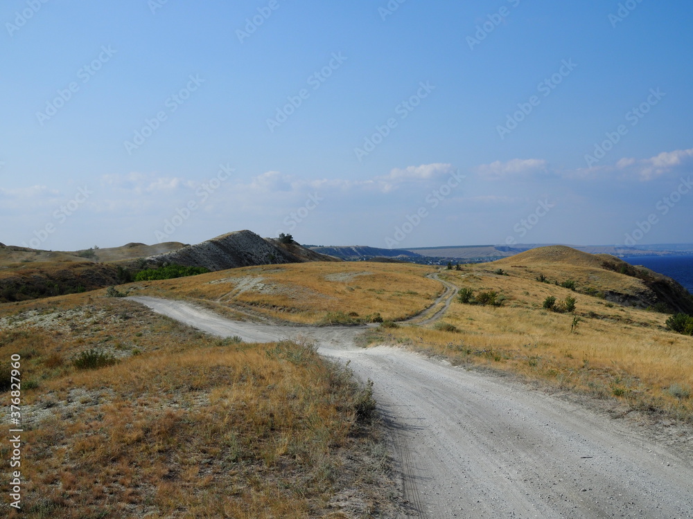 Steppe road, off-road, Elevator in the horizon