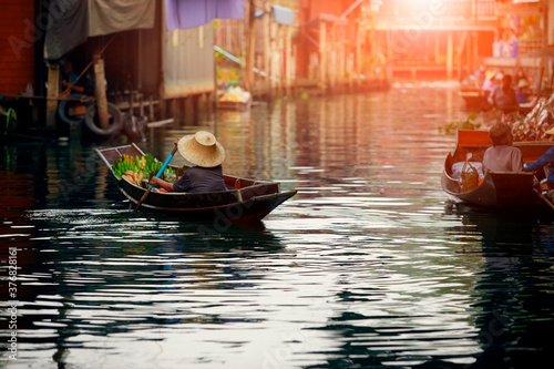 thai fruit seller sailing wooden boat in thailand tradition floating market © stockphoto mania