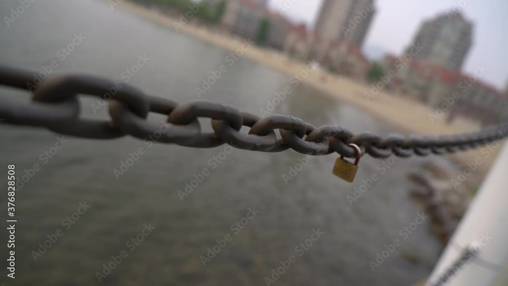 love lock on a chain guard rail on the lake side boardwalk in down town Kelowna. love lock on a chain guard rail on the lake side boardwalk in down town Kelowna.