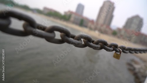 love lock on a chain guard rail on the lake side boardwalk in down town Kelowna. photo