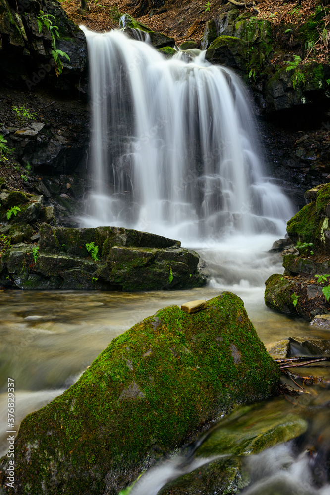 Larger waterfall on the river in the forest. Larger waterfall on the river in the forest.