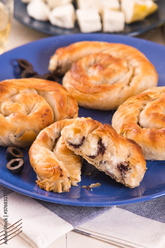 Pastry swirls with cheese and olive filling.
Pastry swirls with cheese and olive filling.