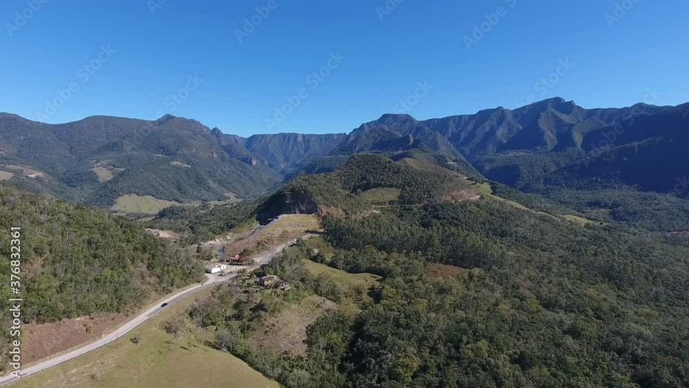 Serra do Rio do Rastro, Santa Catarina. Beautiful road with cars passing, mountains background. Aerial scene in high altitude. Serra do Rio do Rastro, Santa Catarina. Beautiful road with cars passing, mountains background. Aerial scene in high altitude.