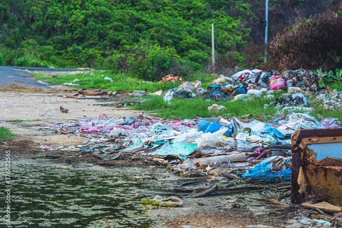 Quadro su tela Spilled recycling man made garbage in park forest near city