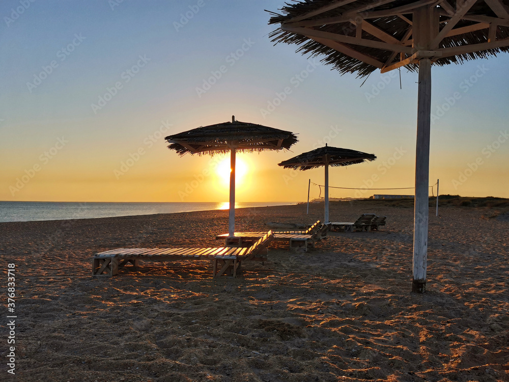 Beautiful view of the sunset over the sea and deserted beach. Bugazskaya spit, Anapa, Russia.