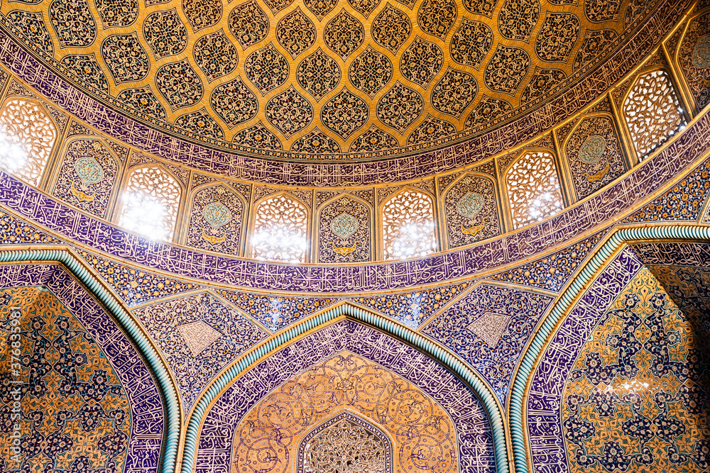 Islamic geometric pattern in Mosque. Islamic arabesque ornament on a mosque walls and ceiling in Iran.
