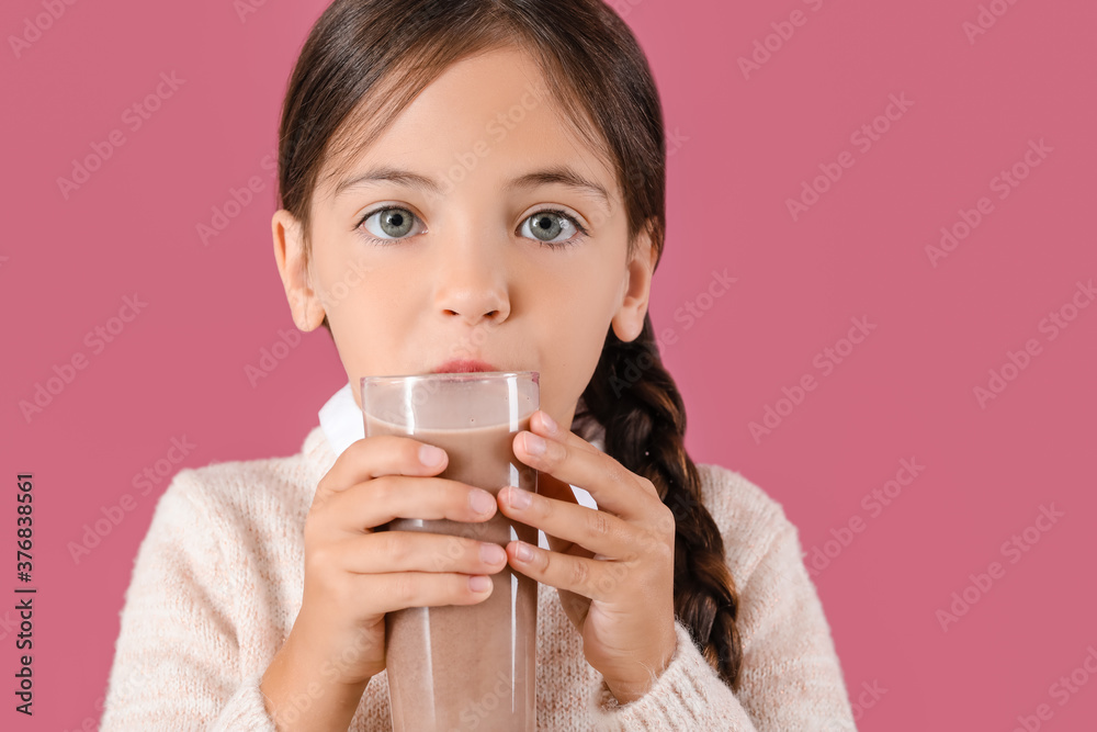 Little girl drinking tasty chocolate milk on color background Little girl drinking tasty chocolate milk on color background