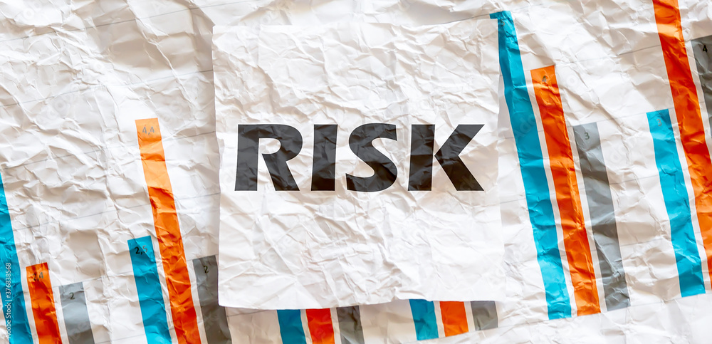 RISK word text on the white memo note crupled sticker on chart ...