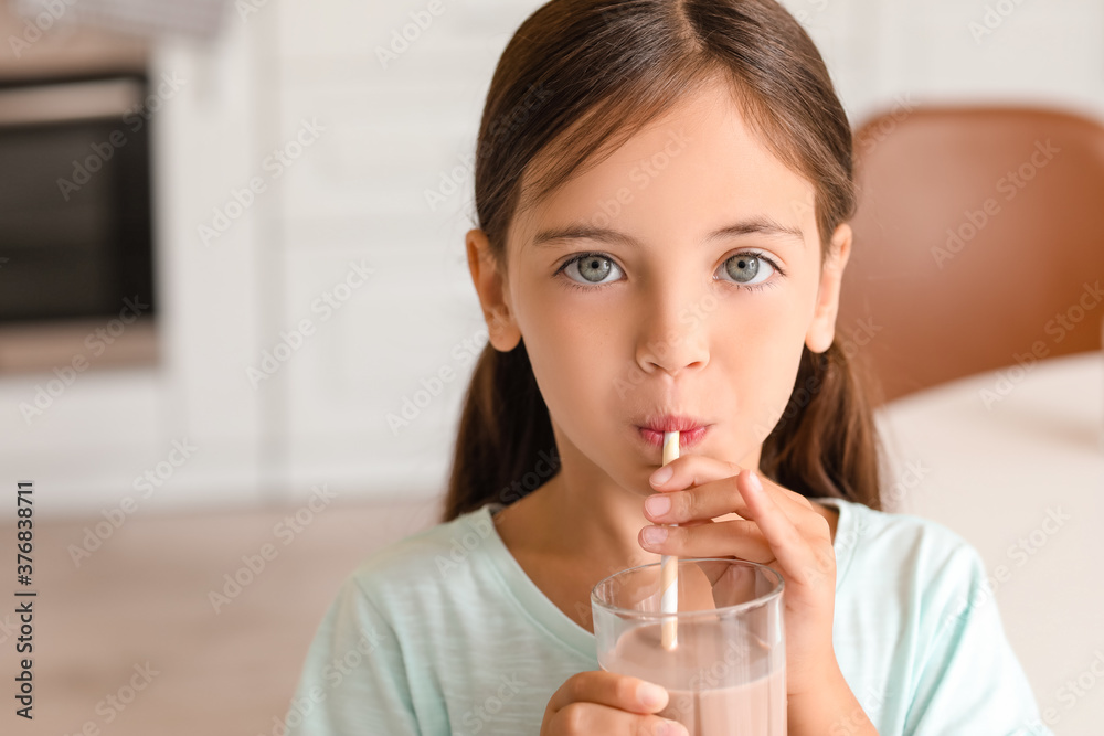 Little girl drinking tasty chocolate milk at home Little girl drinking tasty chocolate milk at home