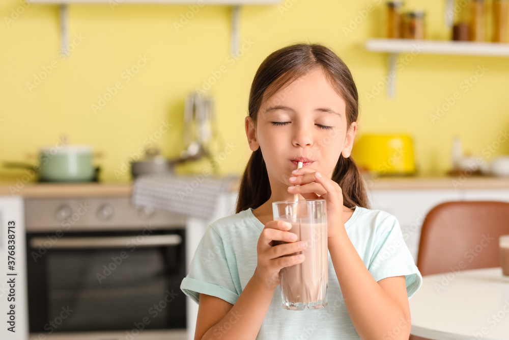 Little girl drinking tasty chocolate milk at home Little girl drinking tasty chocolate milk at home