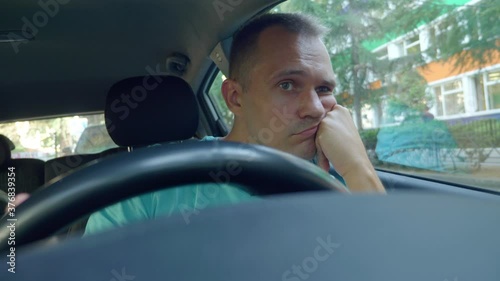 close up. portrait of a tired man driving a car in a traffic jam