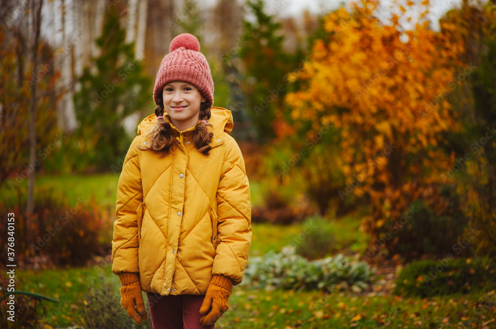 cute kid girl walking in autumn garden or park, wearing warm stylish clothes cute kid girl walking in autumn garden or park, wearing warm stylish clothes