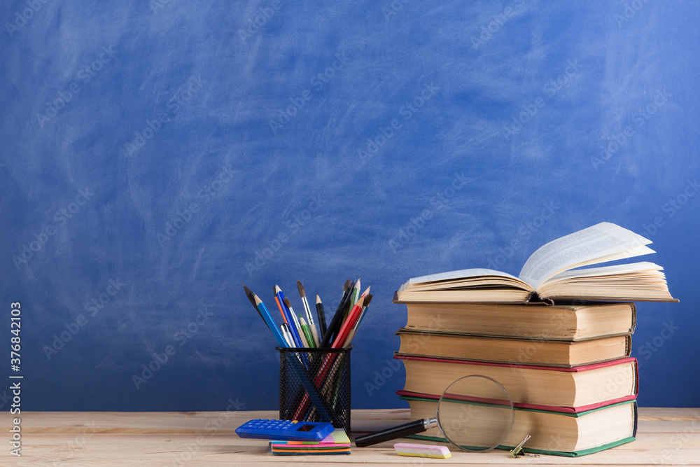 Education concept - books on the desk in the auditorium Education concept - books on the desk in the auditorium