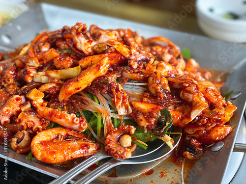 Roasted Webfoot octopus, fork. korean hot chilly food.