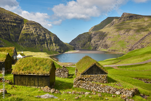 Picturesque green landscape with black houses in Faroe islands. Saksun photo