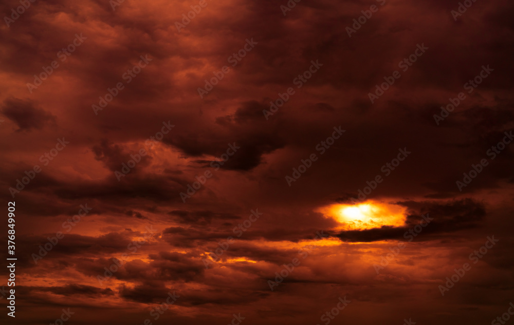 Dramatic red cloudy sky abstract background. Red and black clouds on sunset sky. Warm weather background. Art picture of sky at dusk. Sunset abstract background. Dusk and dawn concept. Cloudscape.