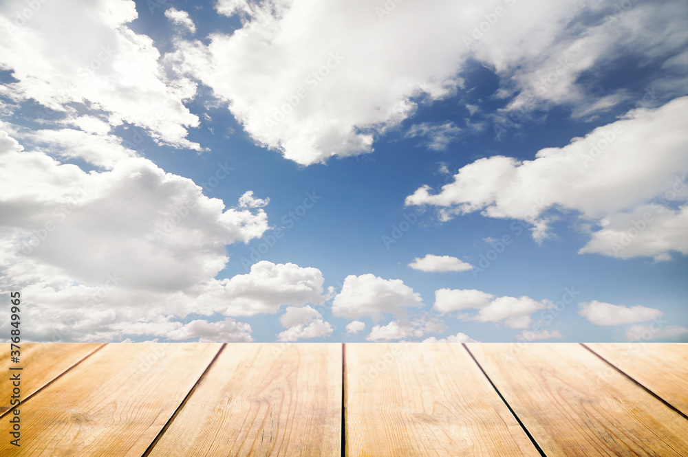 wooden table and sky clouds background