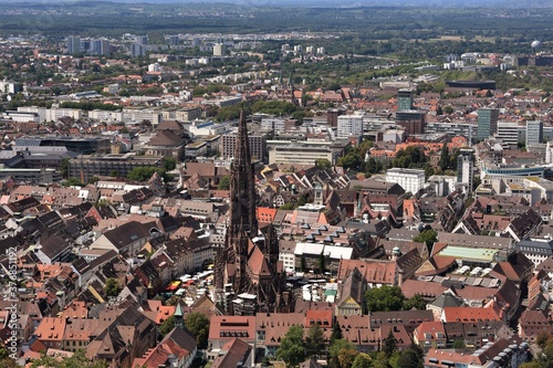 View from lookout Castle Hill Tower on the panorama of the city of Freiburg im Breisgau, Baden-Württemberg, Germany. On the picture is visible old center with medieval cathedral, Freiburg Münster. 