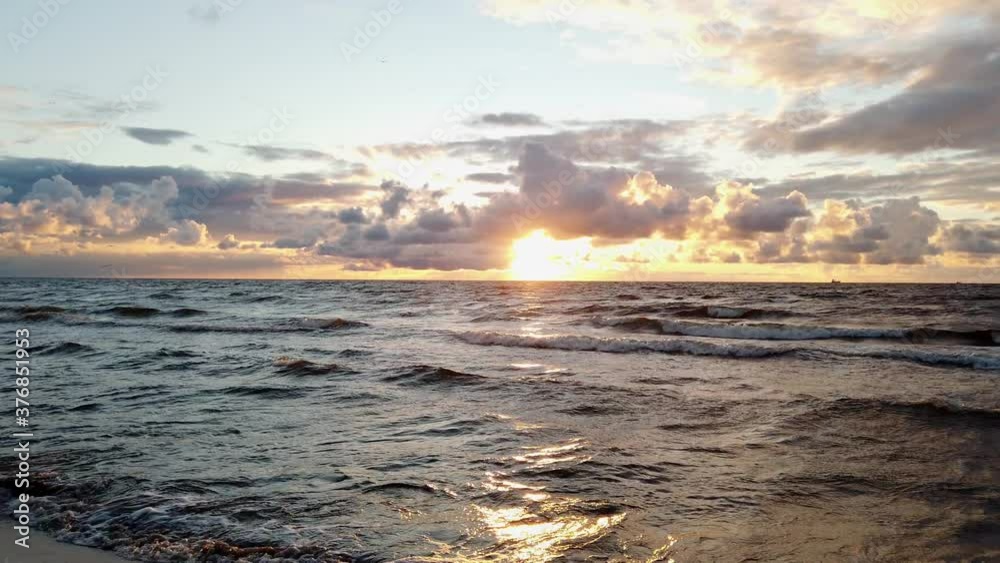 panorama of the sun setting over the sea. Sunset with beautiful clouds. panorama of the sun setting over the sea. Sunset with beautiful clouds.