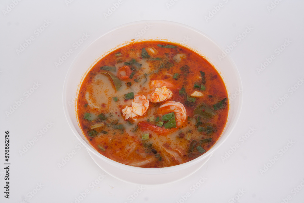 Tom Yam kung Spicy Thai soup with shrimp seafood, coconut milk and chili pepper in bowl copy space Tom Yam kung Spicy Thai soup with shrimp seafood, coconut milk and chili pepper in bowl copy space