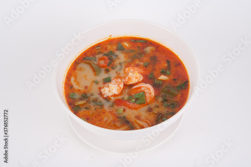 Tom Yam kung Spicy Thai soup with shrimp seafood, coconut milk and chili pepper in bowl copy space