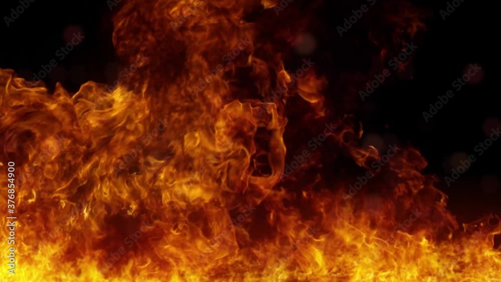 Flaming fire with black background and flying sparks Flaming fire with black background and flying sparks