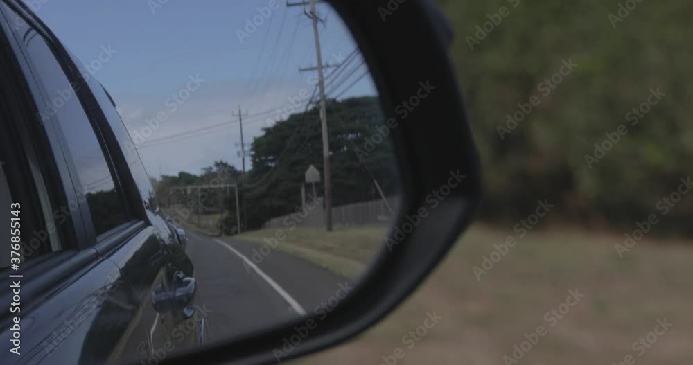 Driving on road while looking back into the rear mirror Driving on road while looking back into the rear mirror