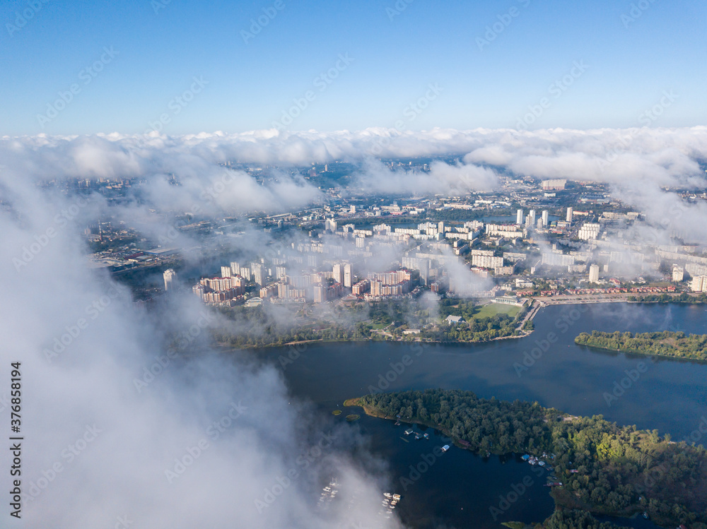 Flying over autumn clouds in Kiev. Sunny morning.