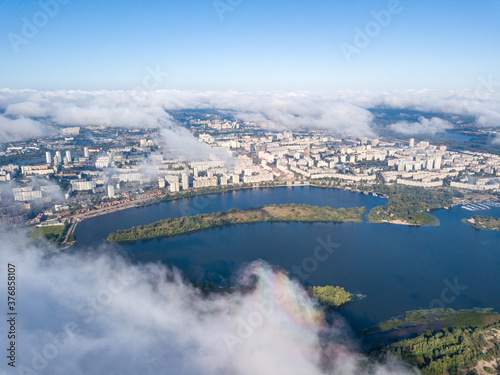 Flying over autumn clouds in Kiev. Sunny morning.