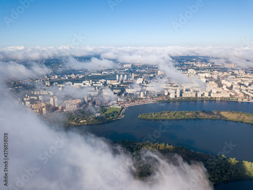 Flying over autumn clouds in Kiev. Sunny morning.