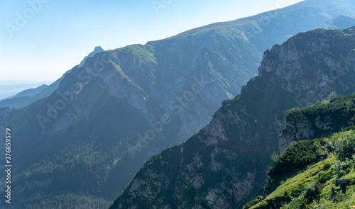 Fototapeta Naklejka Na Ścianę i Meble -  Panoramic view of the Polish Tatra peaks of the mountains during summer morning.