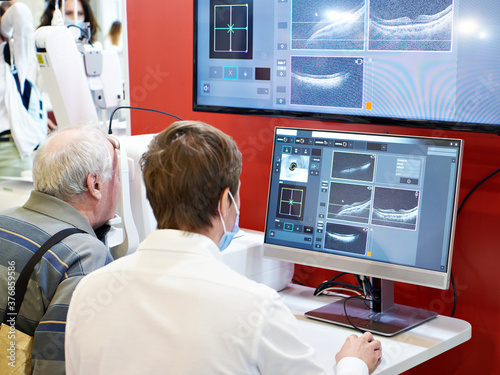 Doctor and patient with ophthalmic spectral optical coherent tomograph