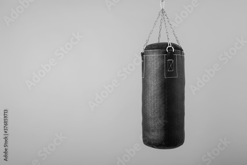 punching bag hanging on colorful background with blank space photo