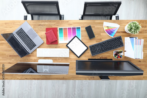 Workplaces in office table chairs tablet smartphone color palette pencils tablet keyboard monitors. Workplace layout concept