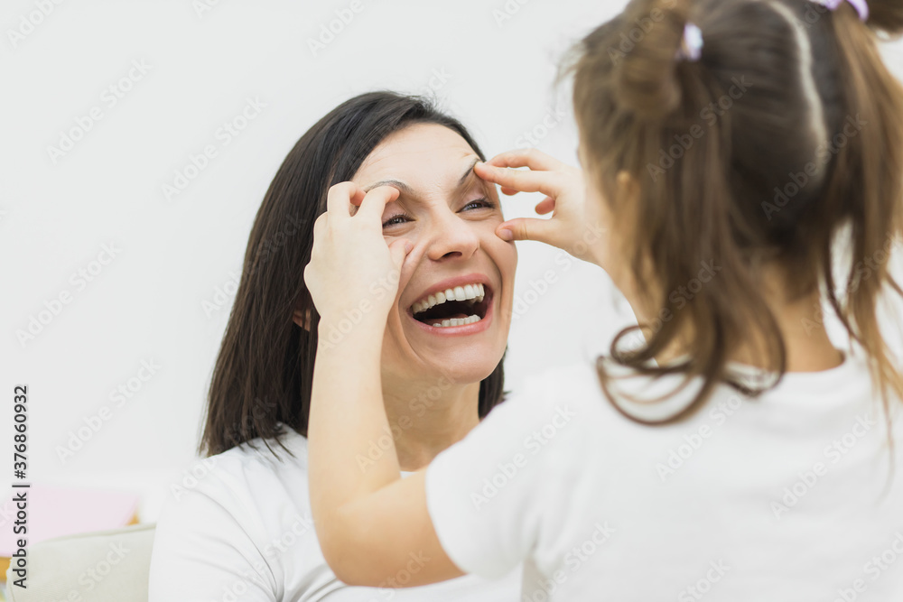 Photo of mother and daughter playing with each other. Photo of mother and daughter playing with each other.