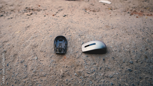 smashed mouse - broken mouse - destroyed mouse - computer mouse broken on concrete ground