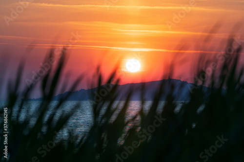 Lake Balaton at sunrise sunset near fonyód with mountain in the background. Tourism in Hungary vacation at the lake in the summer, fishing swimming photo