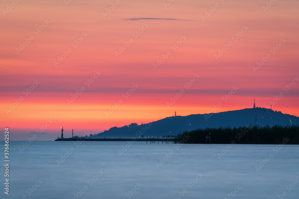 Lake Balaton at sunrise sunset near fonyód with mountain in the background. Tourism in Hungary vacation at the lake in the summer, fishing swimming