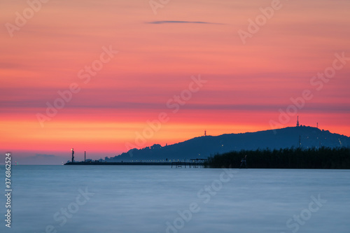 Lake Balaton at sunrise sunset near fonyód with mountain in the background. Tourism in Hungary vacation at the lake in the summer, fishing swimming