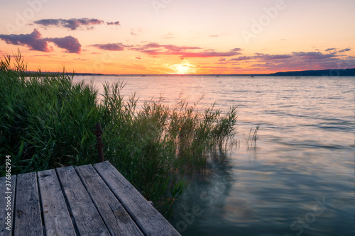 Lake Balaton at sunrise sunset near fony  d with mountain in the background. Tourism in Hungary vacation at the lake in the summer  fishing swimming