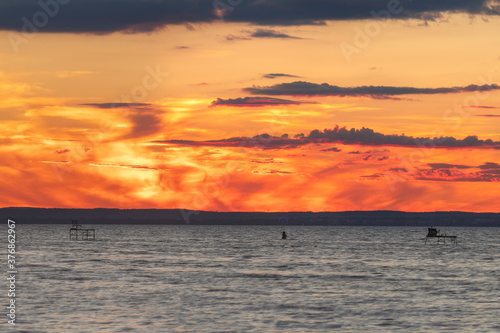 Dramatic sunset at lake balaton in hungary with city Keszthely in the background