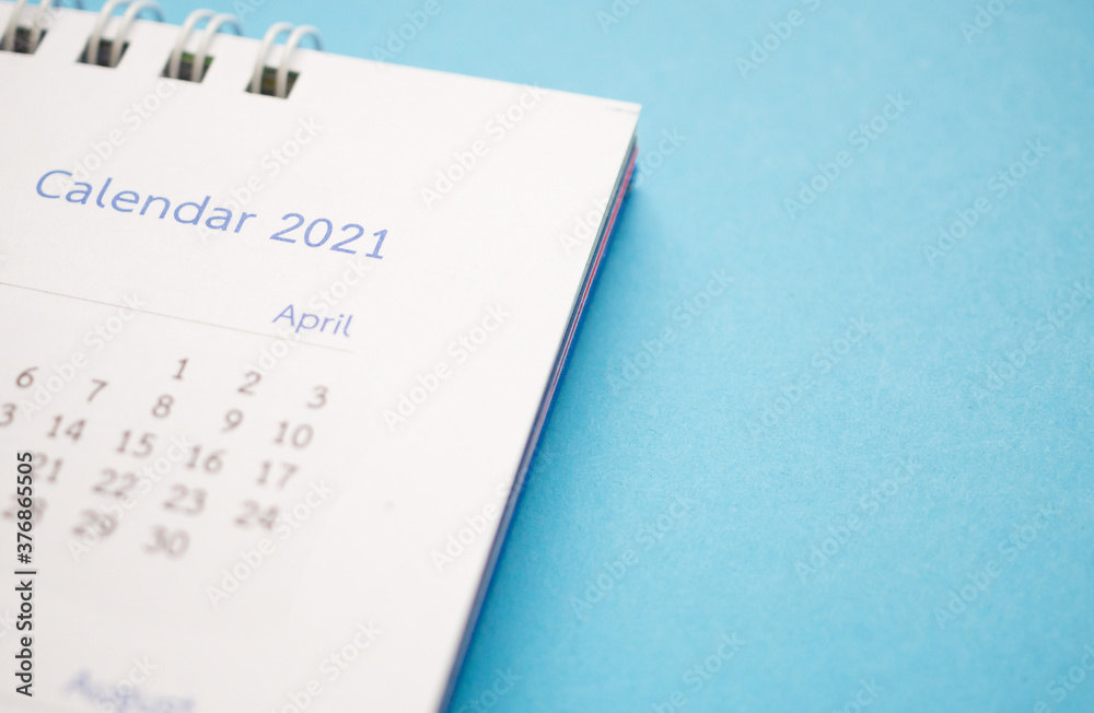 calendar page 2021 close up on blue background business planning appointment meeting concept