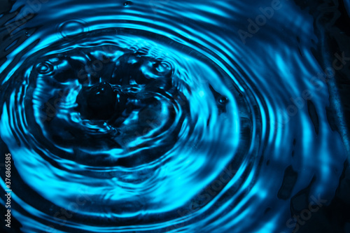 background of circles on the surface of blue fluid