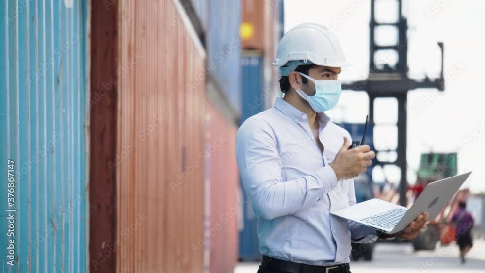 Engineer or construction worker wearing a hard hat and Face mask While working in workplace Such container, factory, warehouse For safety during work. Good health at work. Concept Prevent Coronavirus Engineer or construction worker wearing a hard hat and Face mask While working in workplace Such container, factory, warehouse For safety during work. Good health at work. Concept Prevent Coronavirus