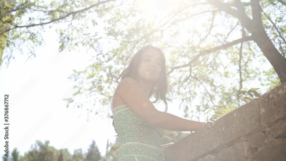 Beautiful woman with green dress looking around the forest, Girona, Spain, slow motion, low angle shot Beautiful woman with green dress looking around the forest, Girona, Spain, slow motion, low angle shot